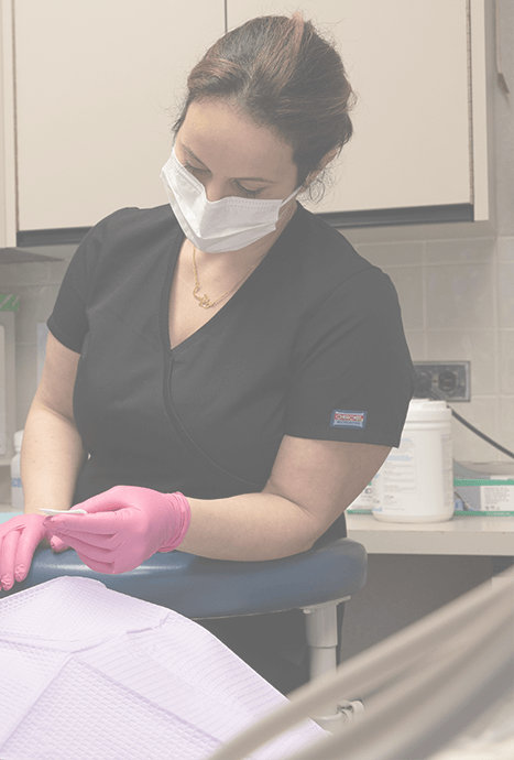 Dental team member treating dentistry patient